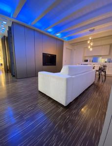 a large white bed in a room with blue lights at Welcome Traveller ATMOSPHERE APARTMENT in Bardolino