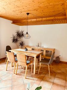 a dining room with a wooden table and chairs at Ferienwohnung an der Aitrach in Aitrach