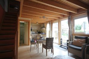 a kitchen and dining room with a table and chairs at Journal aux Lacs-5pers in Froid-Chapelle