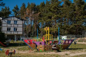 a playground with a play equipment in a park at Apartament 13B Blue Marine Poddąbie in Poddąbie
