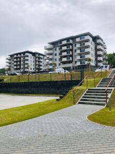 a large building with stairs in front of a park at Apartament Happiness in Jelenia Góra +27 photos