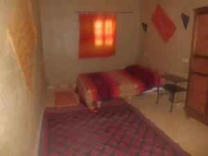 
a bedroom with a red bed and red walls at Camel Trek Bivouac in Merzouga
