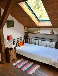 a bedroom with a bed and a window in a attic at Cicha Woda in Pieszyce