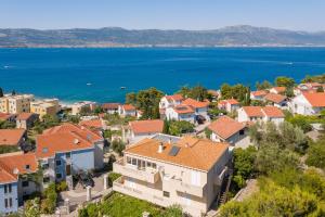 an aerial view of a town with houses and the water at Secret Escape Penthouse in Slatine