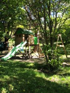 a playground with a slide and a tree at Gîte Au Coeur Du Pays Cathare in Fanjeaux