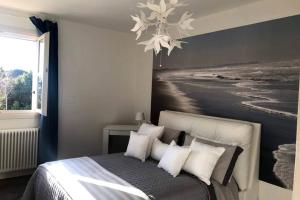 a bedroom with a bed with a painting on the wall at Luna27 in Toscolano Maderno
