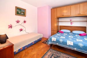 a bedroom with a bed and a bunk bed at Apartment Brle in Poreč