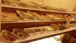 a shelf filled with lots of different types of food at Gevher Hotel in Kayseri