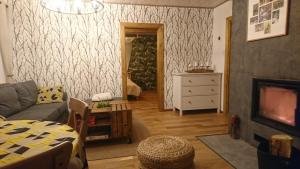 a living room with a couch and a tv at Cicho Cichuteńko in Narew