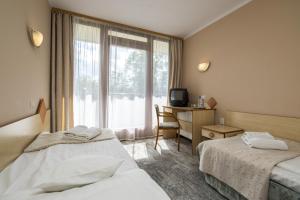 Łóżko lub łóżka w pokoju w obiekcie Geovita Zakopane