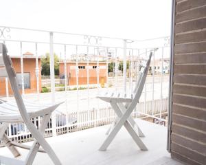 a pair of chairs sitting on a balcony at Civico 43c in Porto San Giorgio