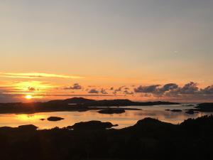 a sunset over a large body of water at Village Way Apartments in Kincasslagh