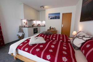 a bedroom with two beds with red blankets at Magic Moments in Brail