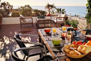 a table with a plate of food on a patio at ¡ VAMOS A LA PLAYA ! in Carboneras