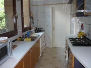 a kitchen with a sink and a stove at Il Giardino Segreto in Imola