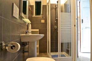 a bathroom with a sink and a shower at La Rue in Tortoreto Lido