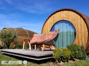 a couple of chairs sitting on a deck in front of a building at The Wine House Hotel - Quinta da Pacheca in Lamego