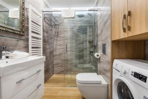 Un baño con inodoro y ducha de cristal. en Happy Stay OldNova Deluxe Apartment 366, en Gdansk 29 fotos más