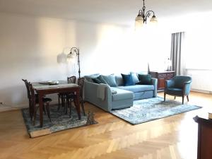 a living room with a couch and a table at Apartament Grunwaldzka in Sopot