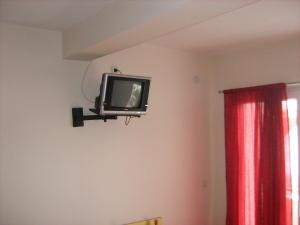 a tv on a wall in a room at Mitko's Guest House in Ohrid