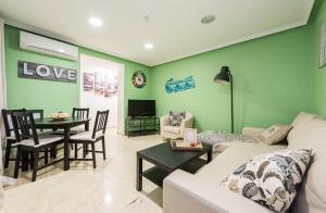 a living room with a white couch and a table at Boutique Apartments in the Heart of Madrid in Madrid