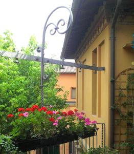 a street light with flower boxes on a building at Il Giardino Segreto in Imola