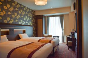 Ένα ή περισσότερα κρεβάτια σε δωμάτιο στο Hotel Monterey Fukuoka