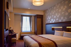 Ένα ή περισσότερα κρεβάτια σε δωμάτιο στο Hotel Monterey Fukuoka