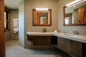 a bathroom with two sinks and a mirror at Stoneridge Estate in Queenstown