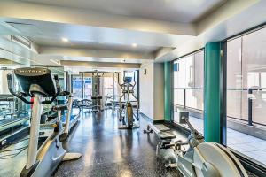 a gym with several treadmills and machines in it at Horizons 1402 - Free carpark in Adelaide