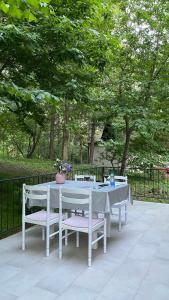 a white table and chairs sitting on a patio at Agape Glamping in Velika Remeta