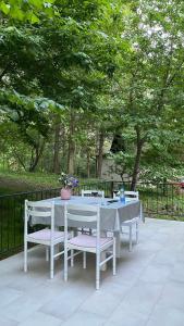 a white table and chairs sitting on a patio at Agape Glamping in Velika Remeta +28 photos