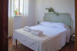 Posteľ alebo postele v izbe v ubytovaní Tenuta San Calogero Appartamento Salvia + 21 fotografií