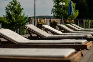 a row of chaise lounges sitting next to a fence at Greenwald by USTA Hotels in Verkhnyaya Sysert'