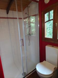 La salle de bains est pourvue d'une douche et de toilettes. dans l'établissement Les roulottes Vesta, à Léognan