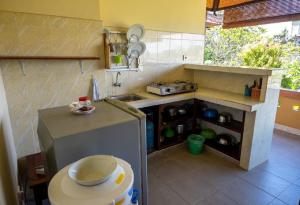a small kitchen with a sink and a counter at Ubud Batik Villa in Ubud