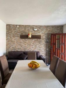 a dining room with a table with fruit on it at Guest House Markovic Lovcen in Cetinje