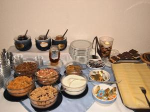 a table topped with bowls and plates of food at Bauernhof Strasserhof in Söll