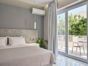 a bedroom with a bed and a large window at Nikos & Maria Studios II in Laganas