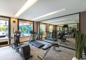 a gym with several treadmills and elliptical machines at Mida Hotel Don Mueang Airport in Bangkok +72 photos