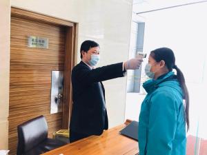 un hombre tomando una foto de una mujer en un espejo en Grand Park Wuxi en Wuxi