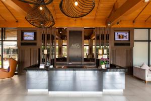 a lobby with a bar in the middle of a building at Mida Hotel Don Mueang Airport in Bangkok