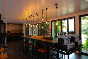 a kitchen with a bar with stools and a counter top at BED Phrasingh-Adults Only in Chiang Mai