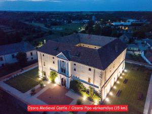 an aerial view of a large white building with lights at Maison Cirmi in Szabadhidvég
