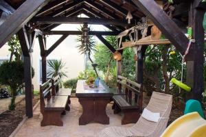 a wooden pergola with a wooden table and chairs at Modern Apartment in Trogir - 70 m² - Parking Included in Trogir