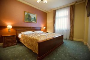 Postel nebo postele na pokoji v ubytování Hotel przy Młynie
