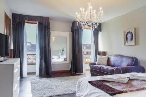a living room with a couch and a chandelier at Rialto Canal View With Terrace and Balcony by Wonderful Italy in Venice