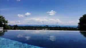 a swimming pool with a view of the mountains at Pearl Villa in Nathon