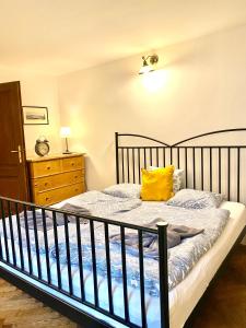 a bedroom with a bed with a yellow pillow on it at Apartmány Nerudova 36 in Prague