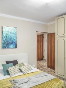 a bedroom with a bed and a painting on the wall at San Marco Square with Canal View by Wonderful Italy in Venice